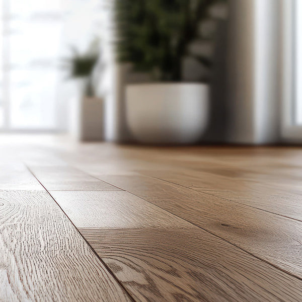 Close-up of a wooden floor with blurred plants and light in the background